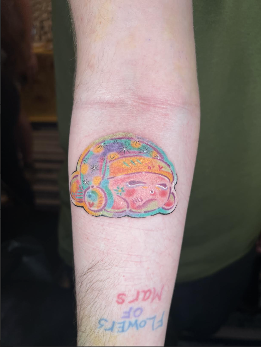 Sleepy Kirby forearm tattoo in bright color