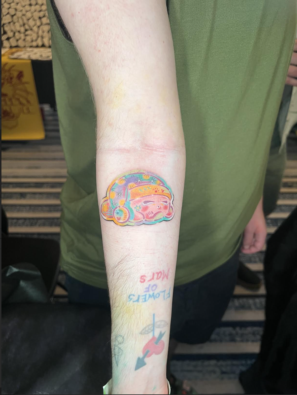 Sleepy pink Kirby forearm tattoo