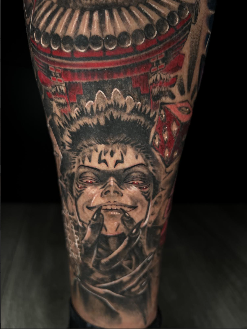 Close-up of an anime character tattoo with red eyes