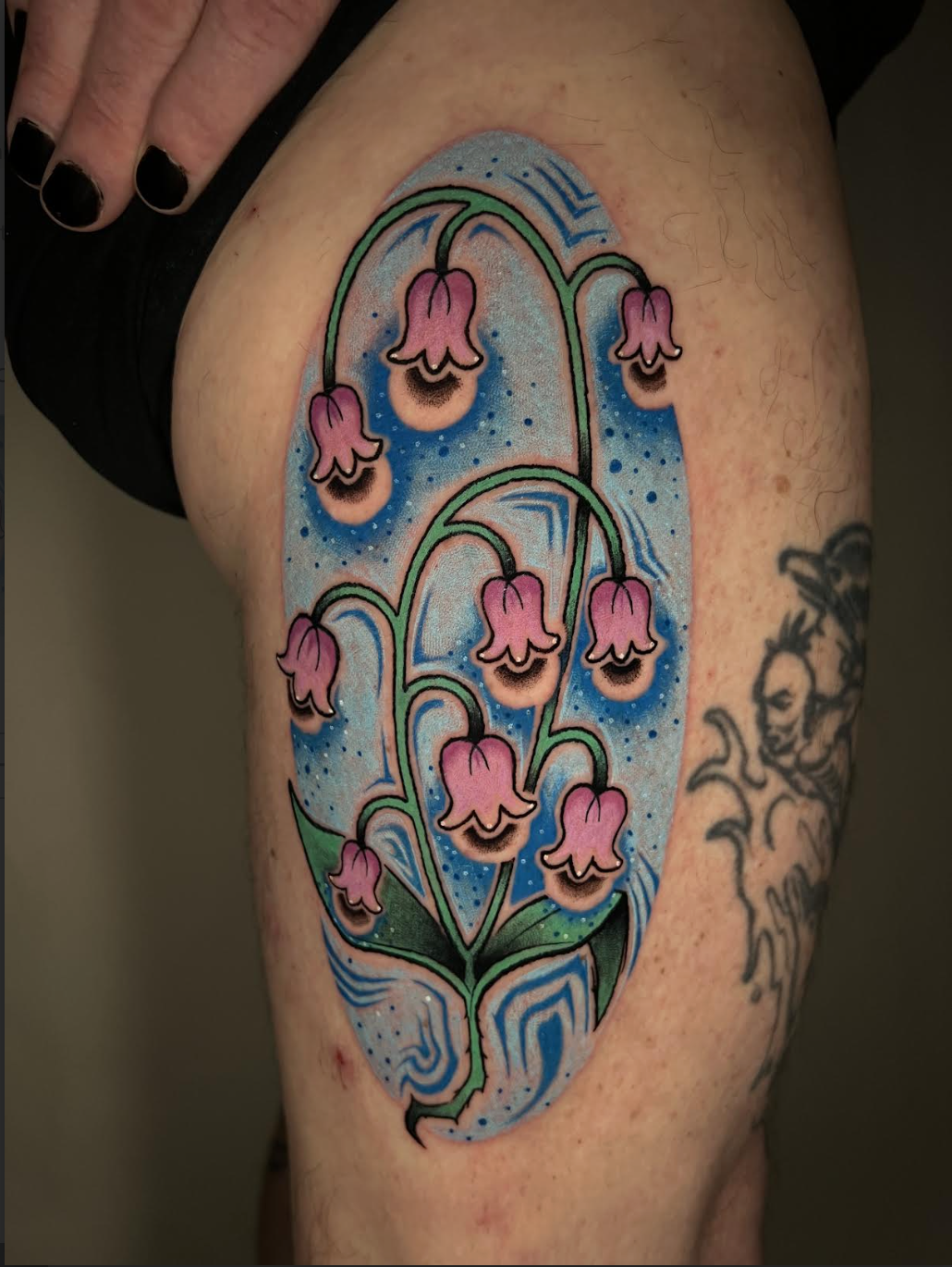Pink flowers inside a starry blue portal tattoo