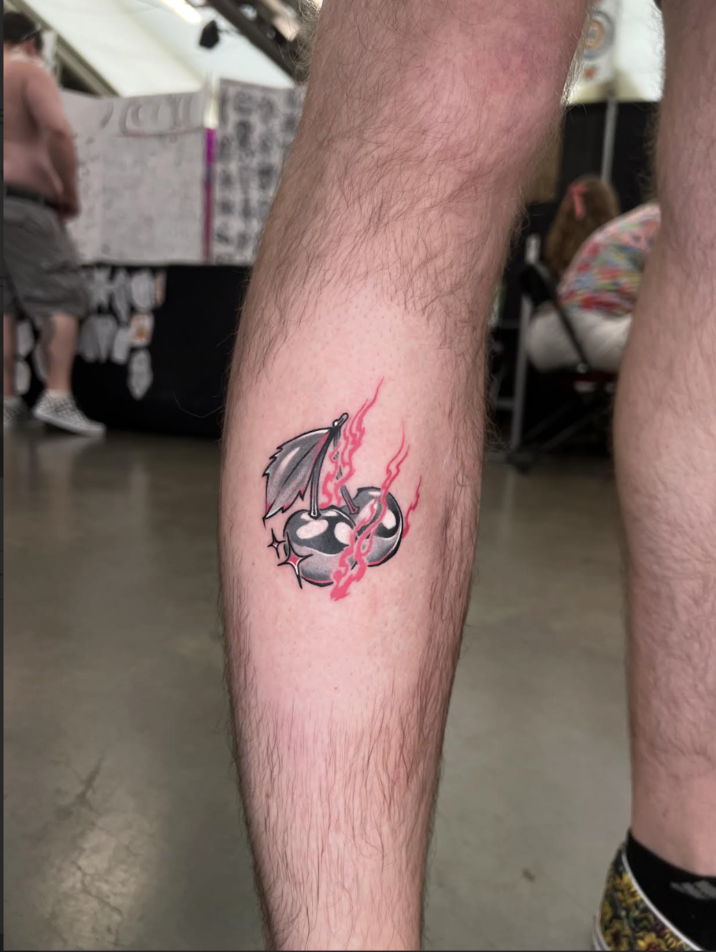 Chrome cherries tattoo with red flame accents