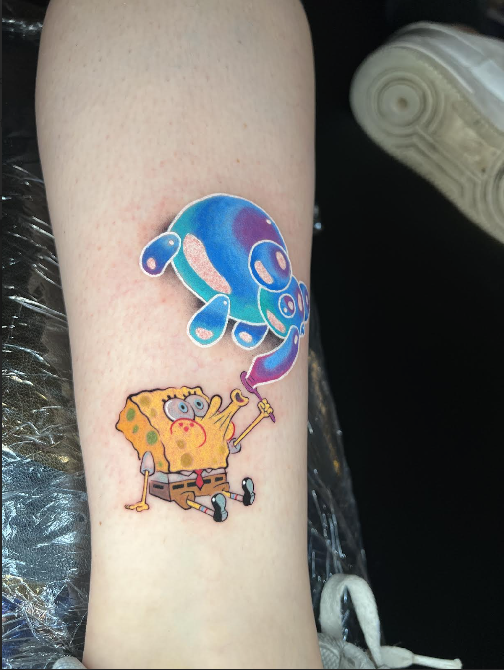 Cartoon sponge character tattoo with a glossy bubble effect